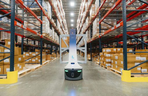 Robot in a warehouse surrounded by racks