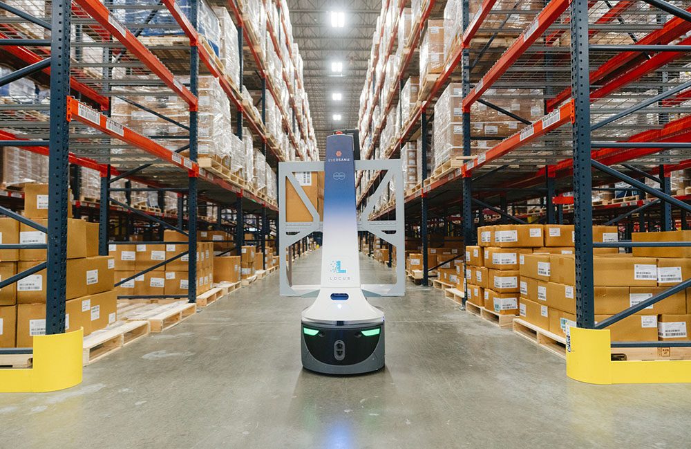 Robot in a warehouse surrounded by racks